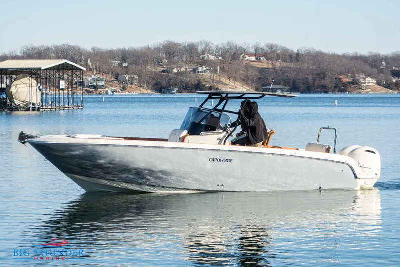 Slide: The Image of 2024 Capoforte FX270 boat on a calm lake with a scenic background. - 5