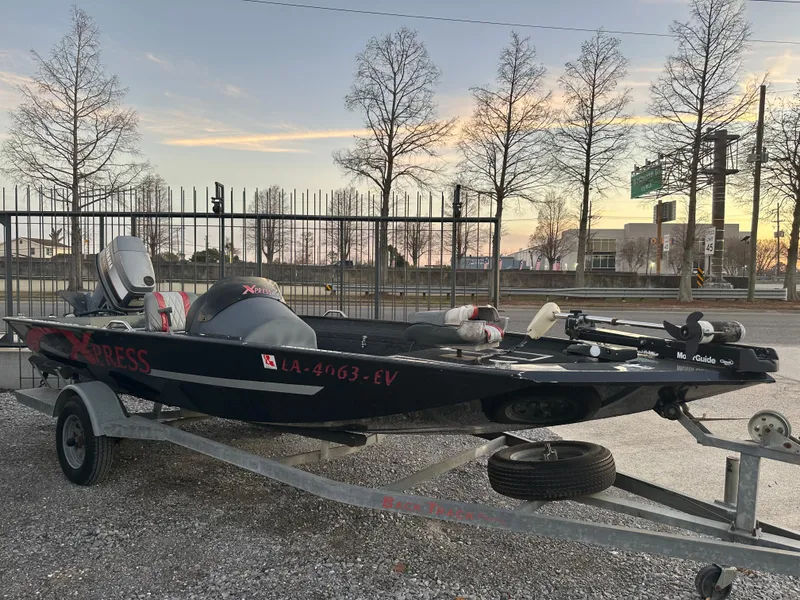 Slide: The Image of 1997 Xpress H51 boat on trailer at sunset. - 2