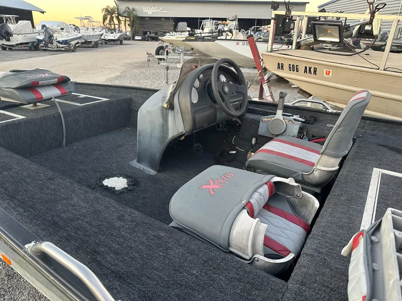 Slide: The Image of 1997 Xpress H51 boat interior with steering wheel and seating in a marina. - 3