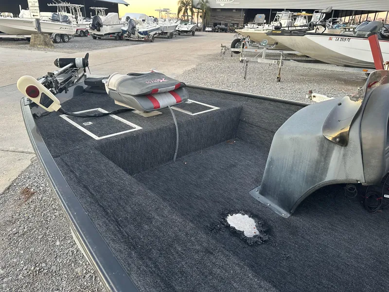 Slide: The Image of 1997 Xpress H51 fishing boat with carpeted deck and seating area. - 6