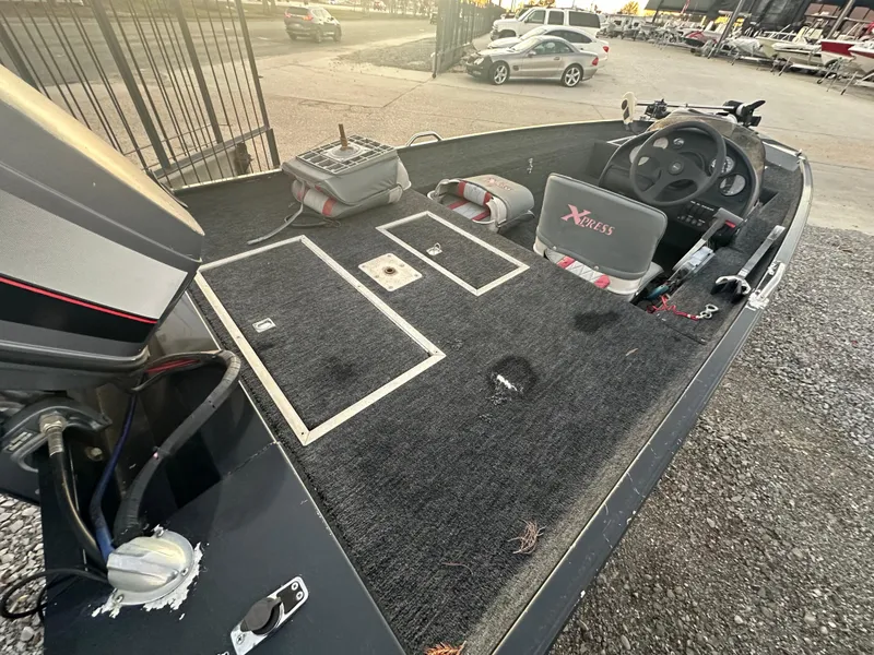 Slide: The Image of 1997 Xpress H51 fishing boat interior with steering wheel and storage compartments. - 7