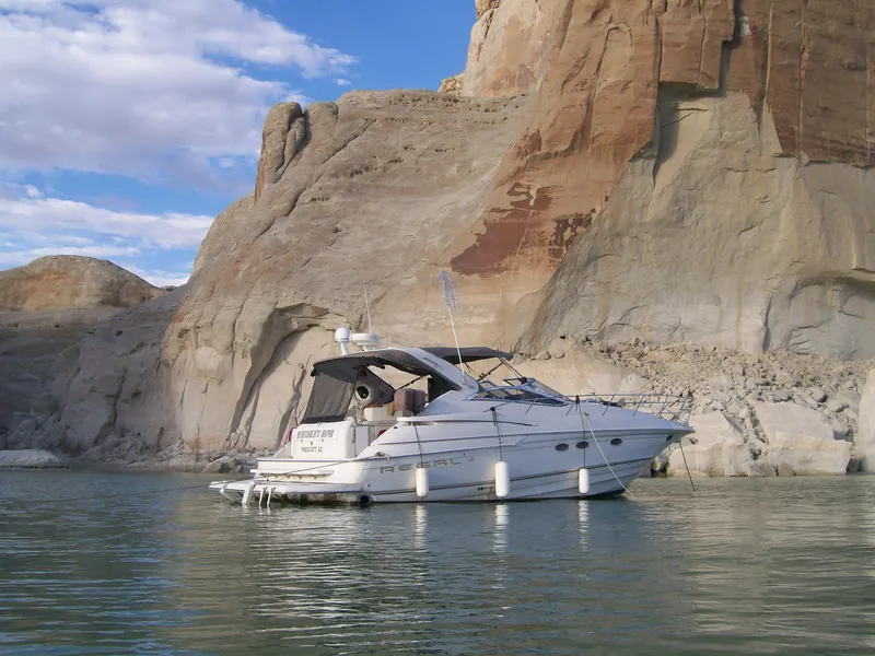 Slide: The Image of 2001 Regal 4160 Commodore yacht anchored near rocky cliffs. - 1