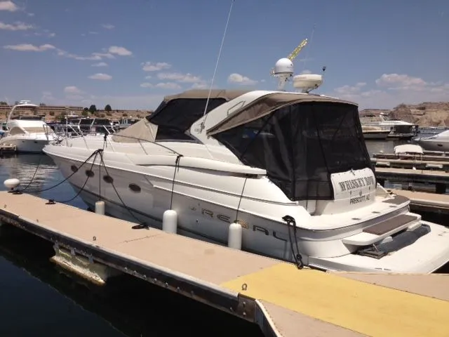 Slide: The Image of 2001 Regal 4160 Commodore yacht docked at a marina. - 13