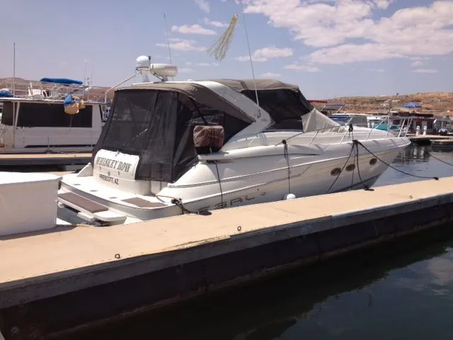 Slide: The Image of 2001 Regal 4160 Commodore yacht docked at marina under clear sky. - 14