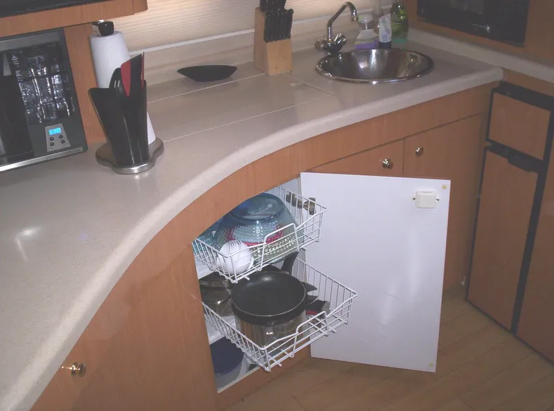 Slide: The Image of 2001 Regal 4160 Commodore kitchen with open cabinet, sink, and countertop appliances. - 19