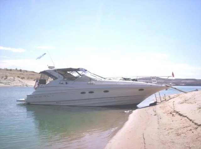 Slide: The Image of 2001 Regal 4160 Commodore yacht beached on a sandy shore. - 2