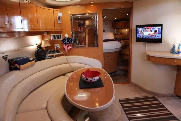 Slide: The Image of 2001 Regal 4160 Commodore yacht interior with cozy seating, TV, and modern amenities. - 27