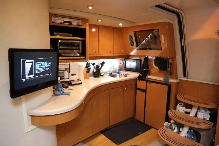 Slide: The Image of 2001 Regal 4160 Commodore yacht kitchen with modern appliances and wooden cabinetry. - 28