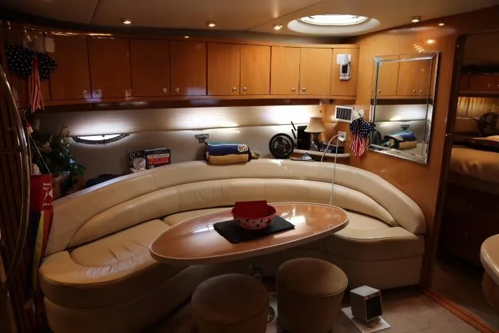 Slide: The Image of Interior of 2001 Regal 4160 Commodore yacht with leather seating and wooden cabinets. - 29