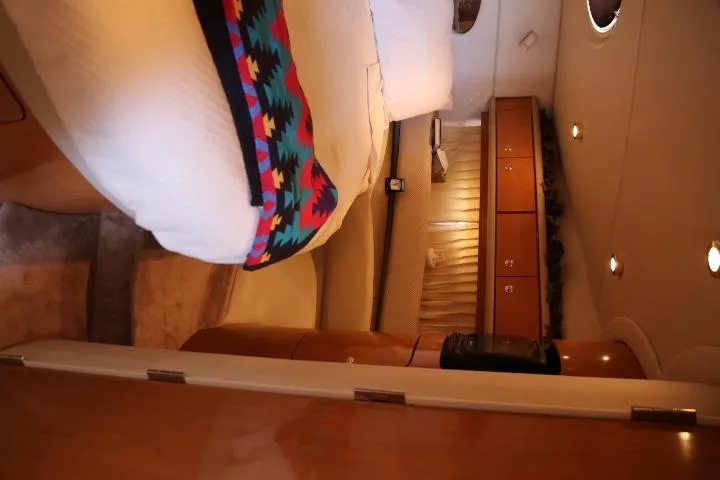 Slide: The Image of Interior cabin of a 2001 Regal 4160 Commodore yacht with bed and wooden cabinetry. - 33