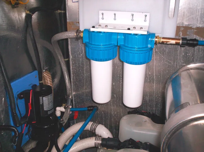 Slide: The Image of 2001 Regal 4160 Commodore engine room with dual water filters and hoses. - 37