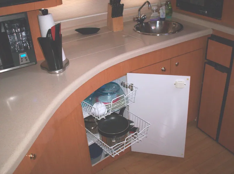 Slide: The Image of 2001 Regal 4160 Commodore yacht kitchen with open cabinet, sink, and countertop appliances. - 38