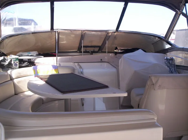 Slide: The Image of Interior of a 2001 Regal 4160 Commodore yacht with seating and table. - 4