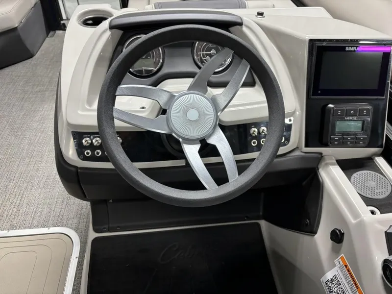Slide: The Image of 2024 Barletta C22CC boat dashboard with steering wheel and control panel. - 10