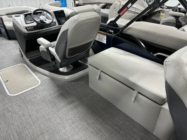 Slide: The Image of 2024 Barletta C22CC boat interior with captain's chair and seating area. - 9