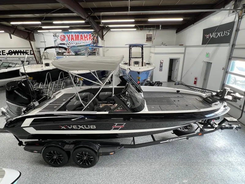 Slide: The Image of 2024 Vexus DVX 20S boat in showroom with Yamaha banner. - 0