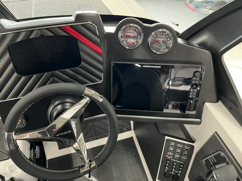 Slide: The Image of 2024 Vexus DVX 20S boat dashboard with steering wheel, gauges, and Humminbird display. - 19