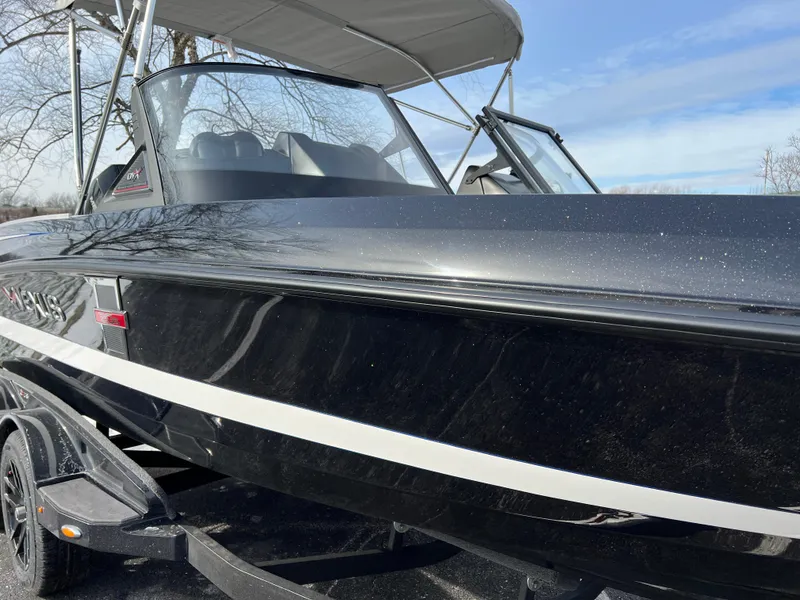 Slide: The Image of 2024 Vexus DVX 20S boat with black exterior and white stripe. - 2