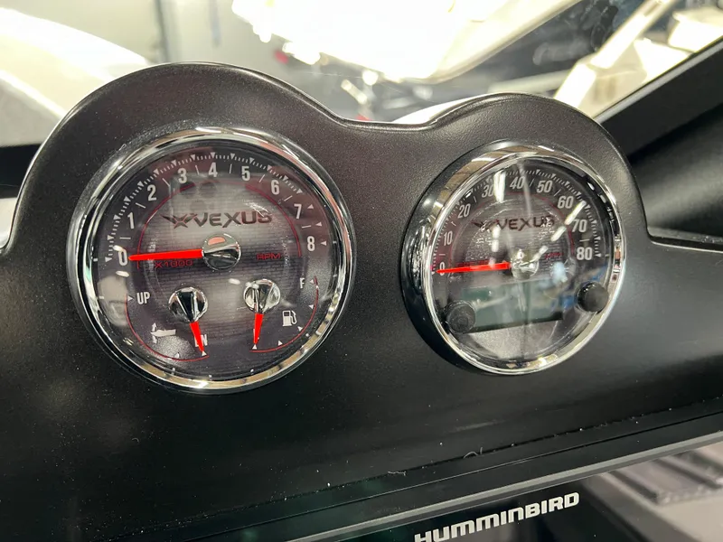 Slide: The Image of 2024 Vexus DVX 20S boat dashboard with speedometer and tachometer gauges. - 20