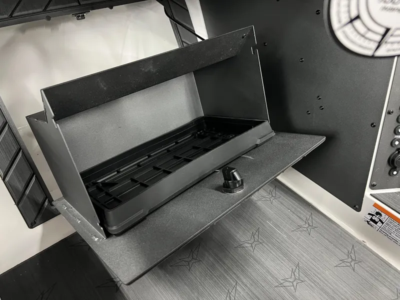 Slide: The Image of 2024 Vexus DVX 20S boat storage compartment with black interior. - 24