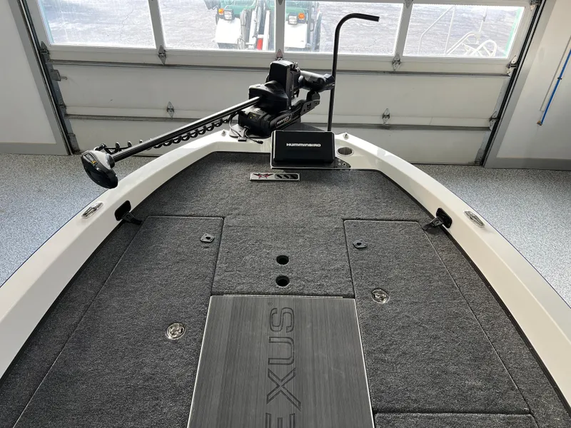 Slide: The Image of 2024 Vexus DVX 20S boat deck with trolling motor in a garage. - 31