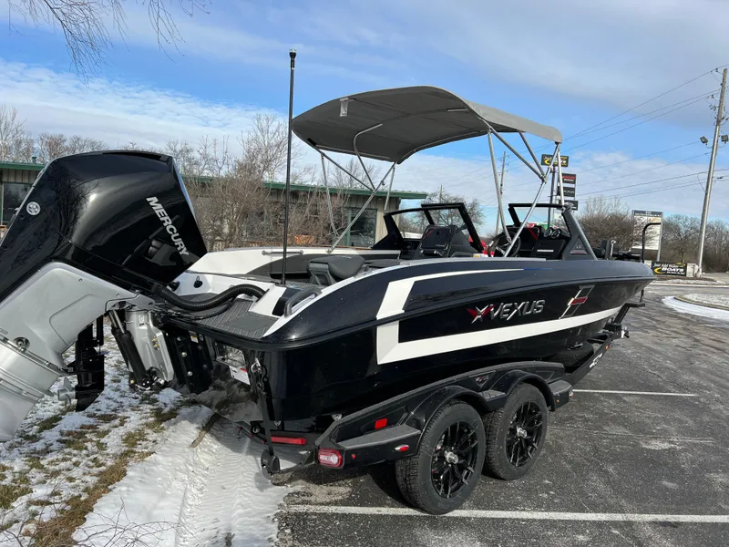Slide: The Image of 2024 Vexus DVX 20S boat with Mercury engine in a snowy parking lot. - 5
