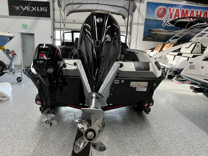 Slide: The Image of 2024 Vexus DVX 20S boat in showroom, rear view with dual outboard motors. - 8