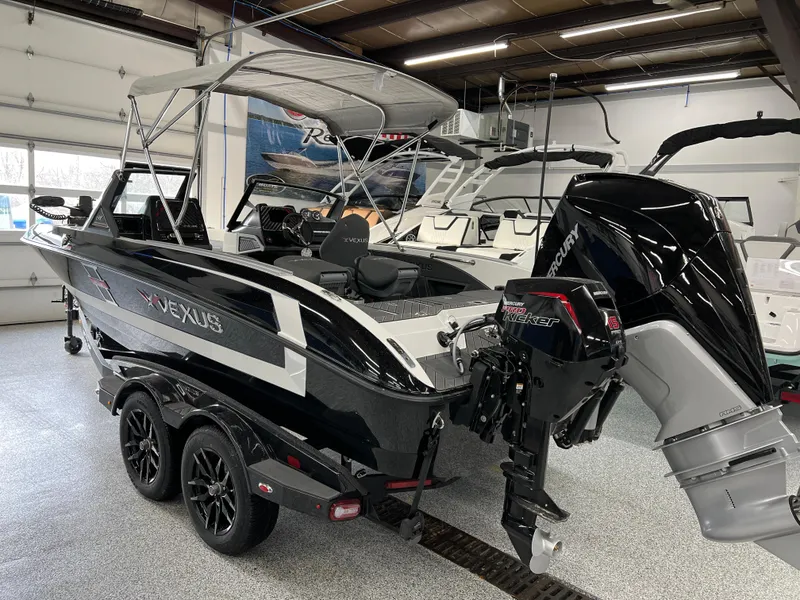 Slide: The Image of 2024 Vexus DVX 20S boat in showroom, rear view with Mercury outboard motor. - 9