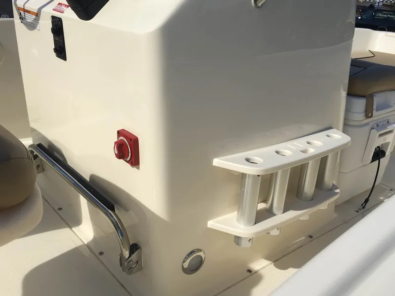 Slide: The Image of 2024 Scout 175 Sportfish boat interior with rod holders and control panel. - 4