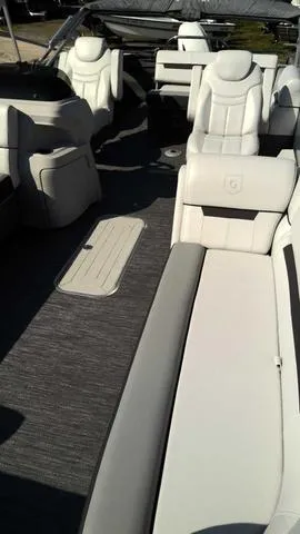 Slide: The Image of 2024 Sweetwater SW 2286 SFL boat interior with white leather seating. - 2