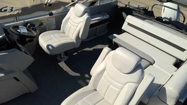 Slide: The Image of 2024 Sweetwater SW 2286 SFL boat interior with white leather seats and steering console. - 3