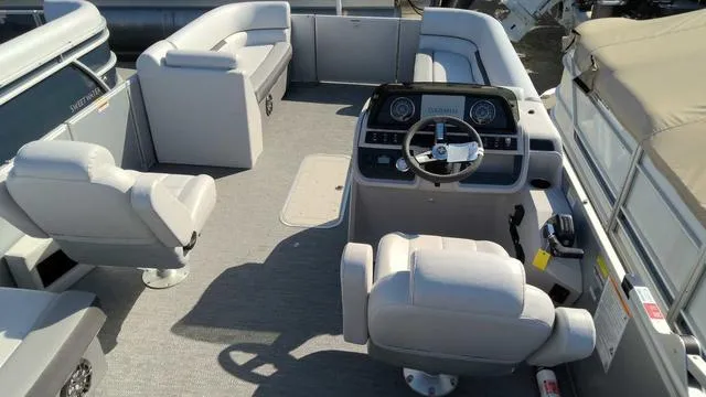Slide: The Image of 2024 Sweetwater SW 2286 SFL pontoon boat interior with helm and seating. - 6