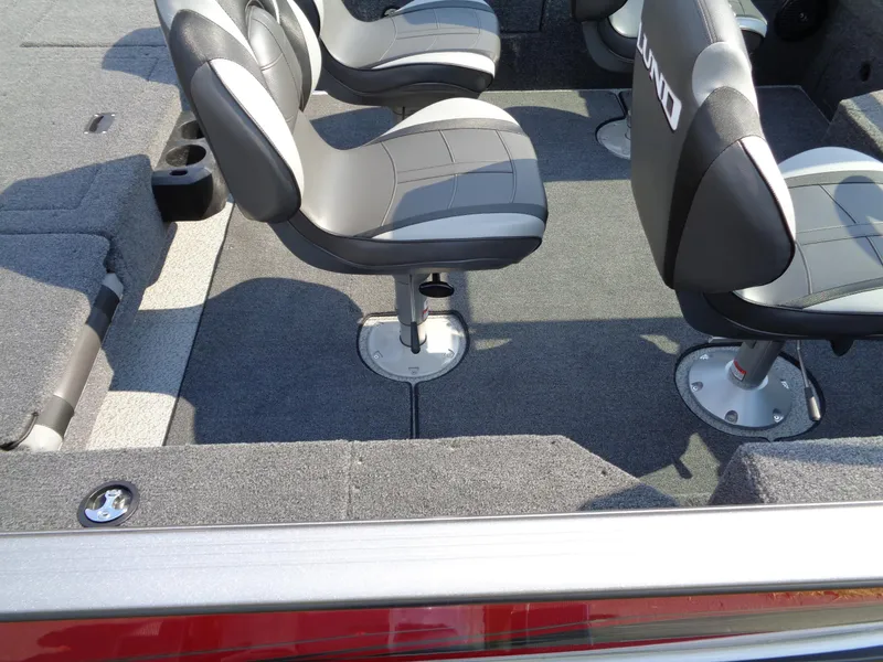 Slide: The Image of 2024 Lund 1875 Impact XS boat interior with gray seating and carpeted flooring. - 13