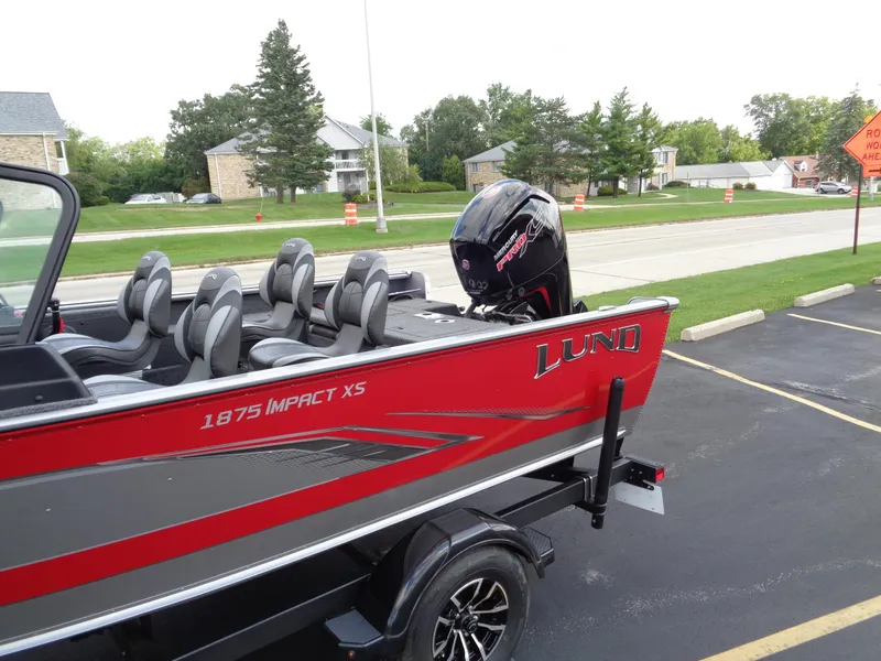 Slide: The Image of 2024 Lund 1875 Impact XS boat with outboard motor in parking lot. - 15
