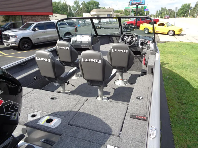 Slide: The Image of 2024 Lund 1875 Impact XS boat interior with four seats and steering console. - 25