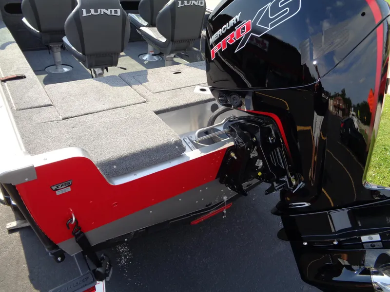 Slide: The Image of 2024 Lund 1875 Impact XS boat with Mercury Pro XS engine, featuring spacious seating and deck. - 8