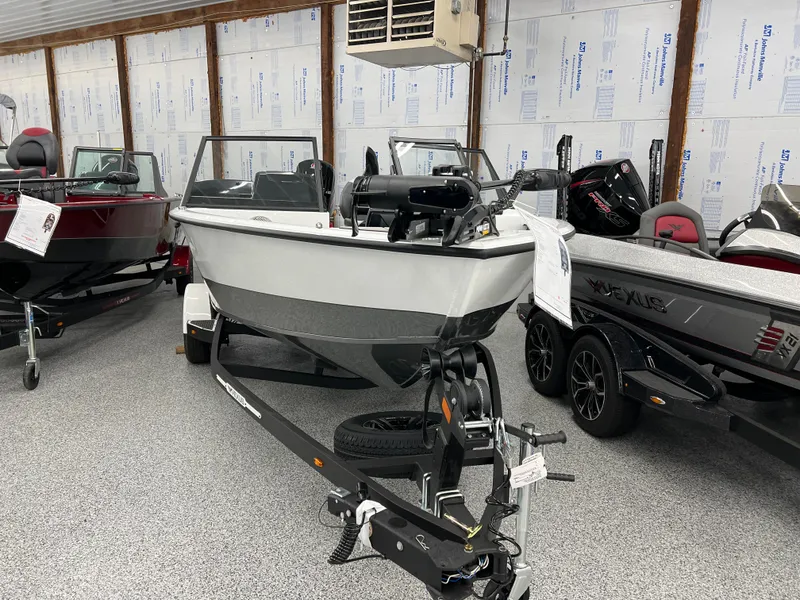 Slide: The Image of 2024 Vexus ADX180 boat on display in a showroom. - 1