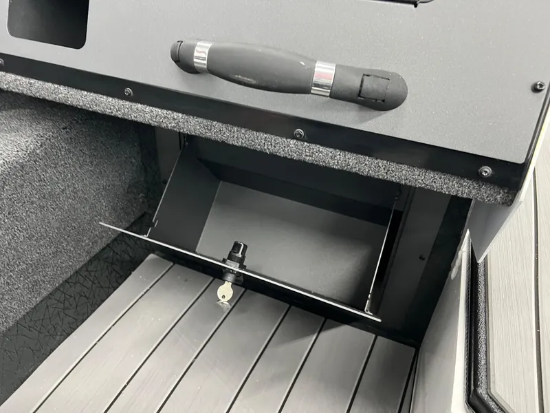 Slide: The Image of 2024 Vexus ADX180 boat storage compartment with lock and handle. - 11