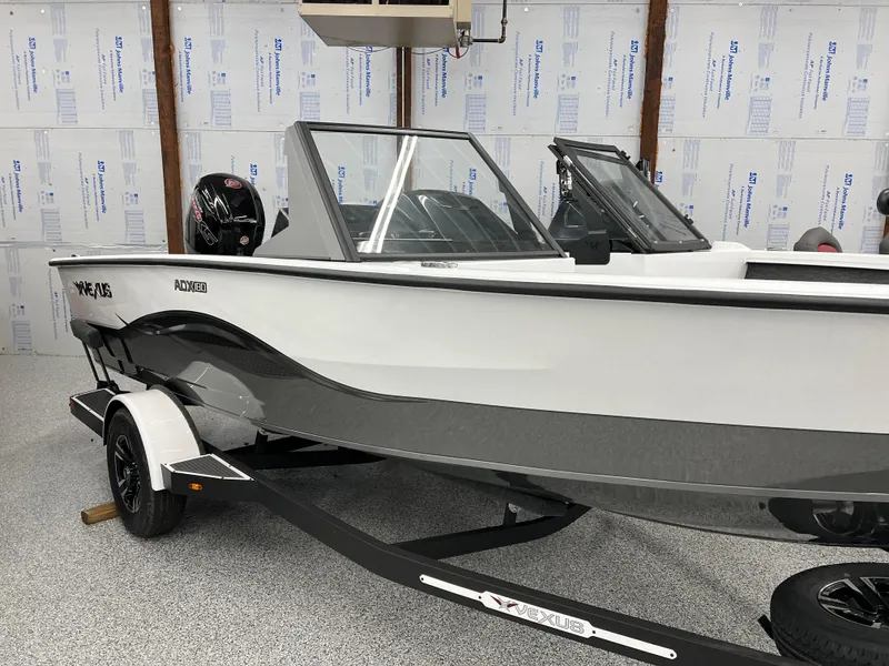 Slide: The Image of 2024 Vexus ADX180 boat in showroom, side view, on trailer. - 2