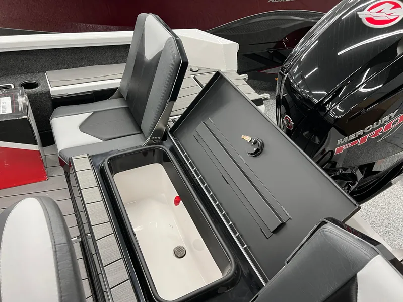 Slide: The Image of 2024 Vexus ADX180 boat interior with storage compartment and Mercury engine. - 23