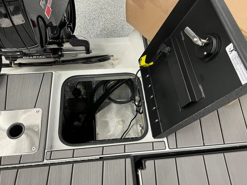Slide: The Image of Open storage compartment on a 2024 Vexus ADX180 boat. - 25