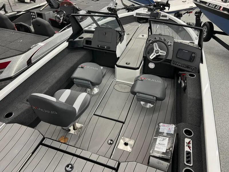 Slide: The Image of 2024 Vexus ADX180 boat interior with dual seats, steering console, and modern dashboard. - 5