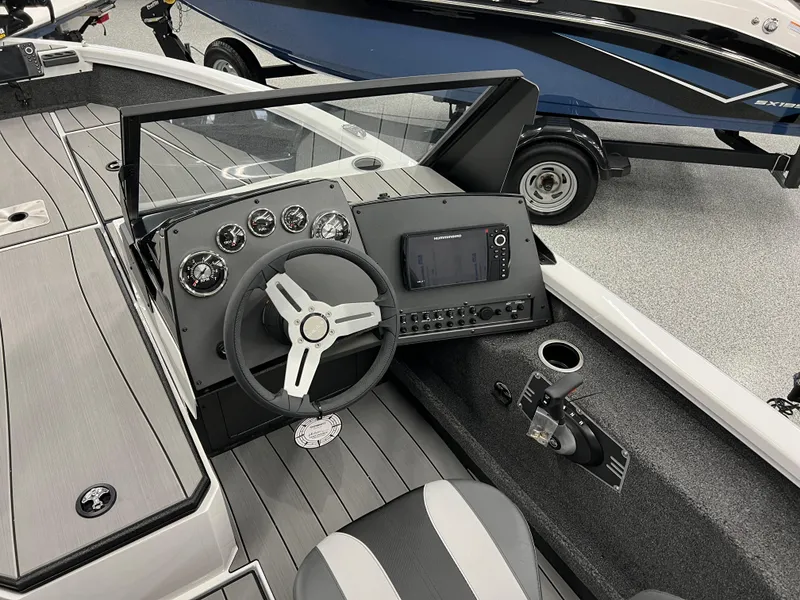 Slide: The Image of 2024 Vexus ADX180 boat cockpit with steering wheel, control panel, and seating. - 7