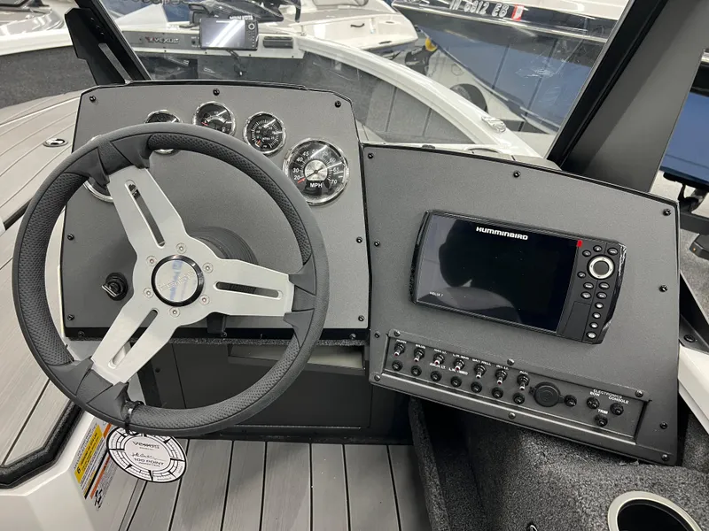 Slide: The Image of 2024 Vexus ADX180 boat dashboard with steering wheel and navigation system. - 8