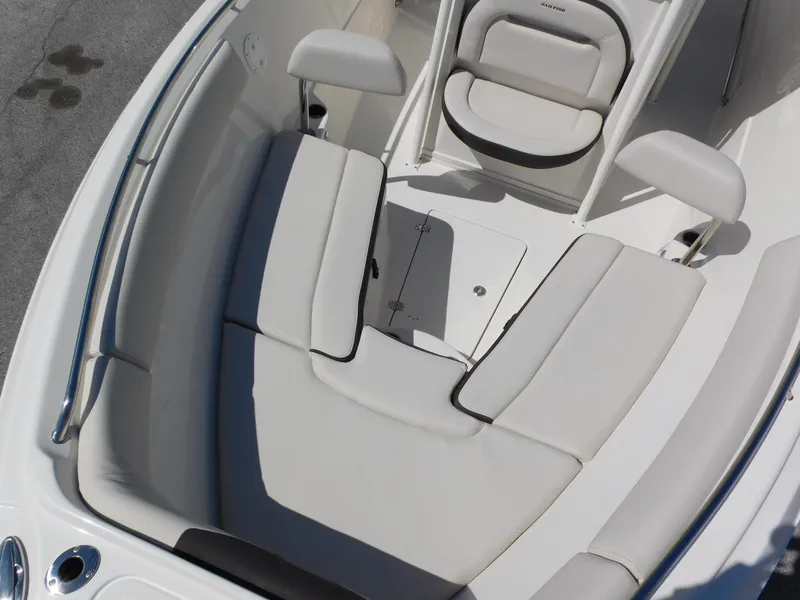 Slide: The Image of 2024 Sailfish 242 CC boat interior with cushioned seating and storage compartment. - 12