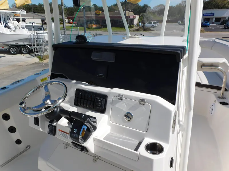 Slide: The Image of 2024 Sailfish 242 CC boat console with steering wheel and controls. - 17