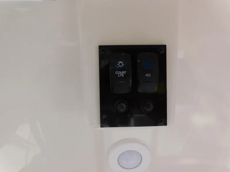 Slide: The Image of Switch panel on 2024 Sailfish 242 CC boat with court lights and accessory buttons. - 24