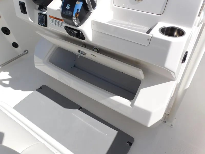 Slide: The Image of 2024 Sailfish 242 CC boat console with open storage compartment. - 29