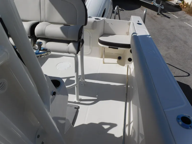 Slide: The Image of 2024 Sailfish 242 CC boat interior with seating and console. - 30