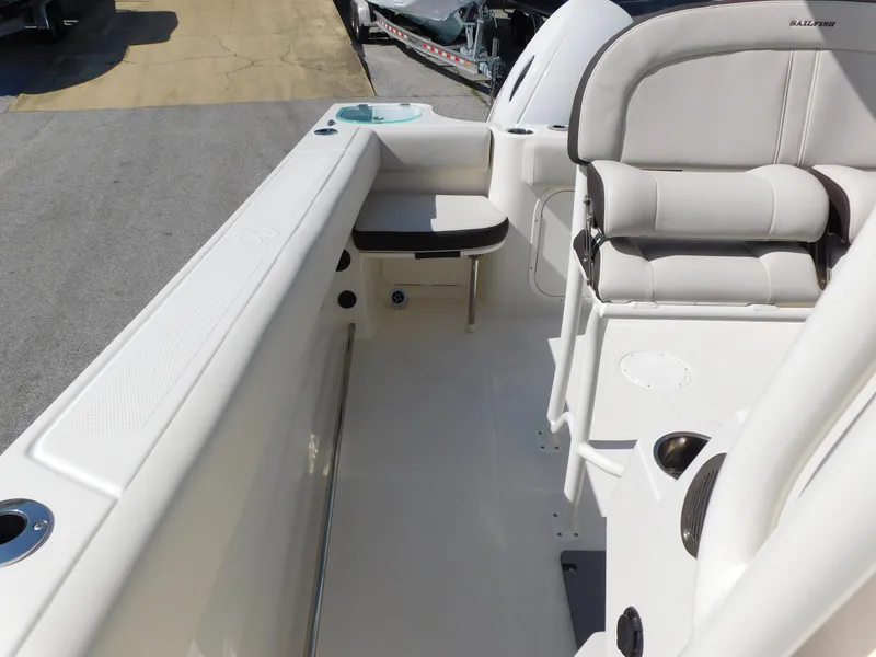 Slide: The Image of 2024 Sailfish 242 CC boat interior with cushioned seating and storage compartments. - 31